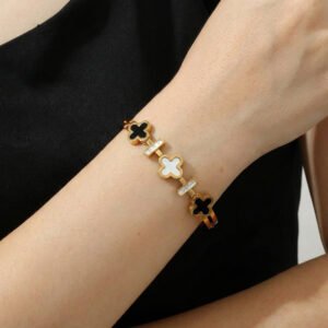 Gold plated bracelet with black and white floral design