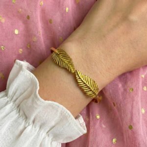 gold toned cuff bracelet with geometric repeating pattern for women