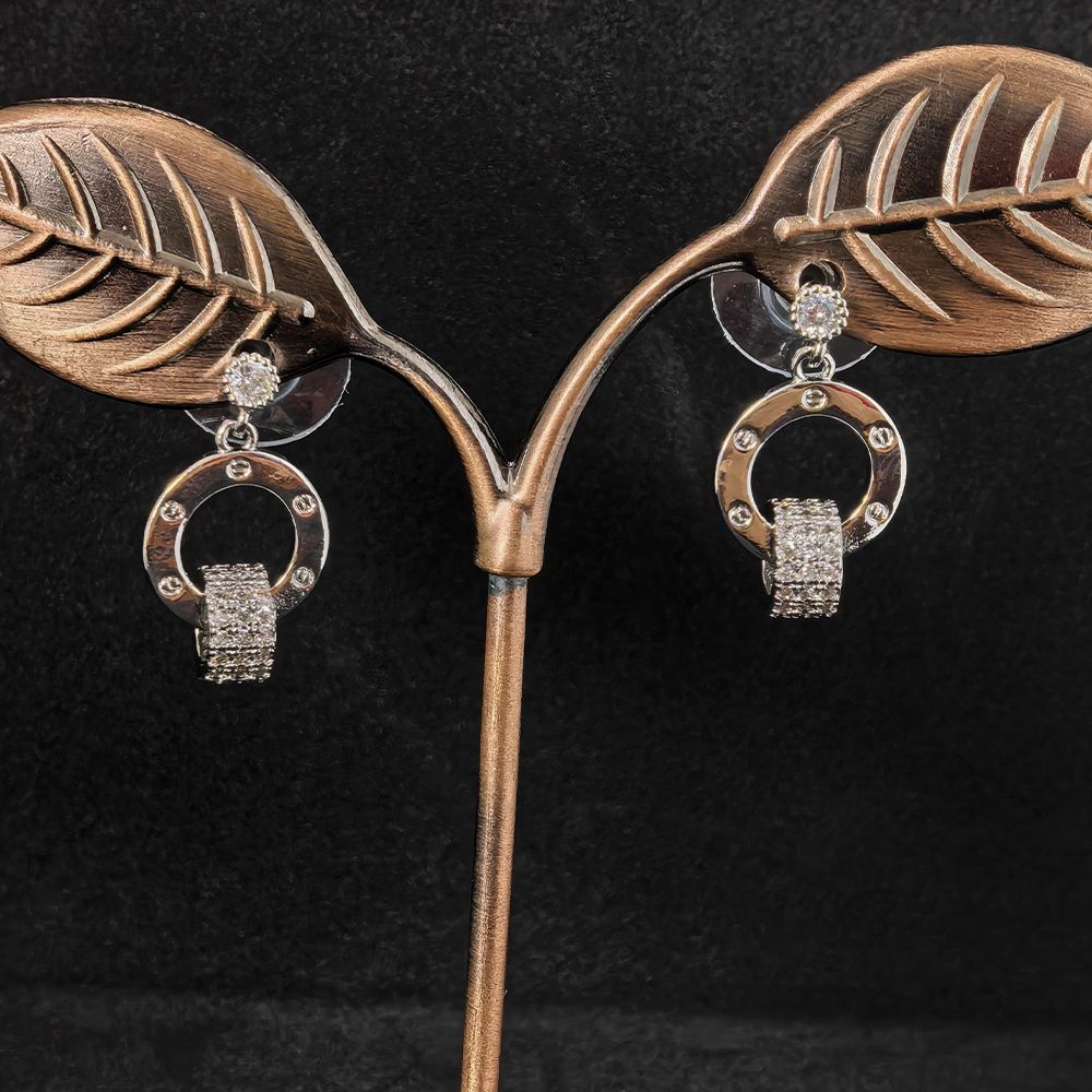 Silver toned circle earrings for women featuring a sleek round design embellished with shimmering white stones.